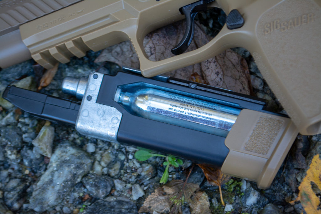 The magazine contains both the CO2 cylinder and a sub-magazine with a 20-round pellet belt.
