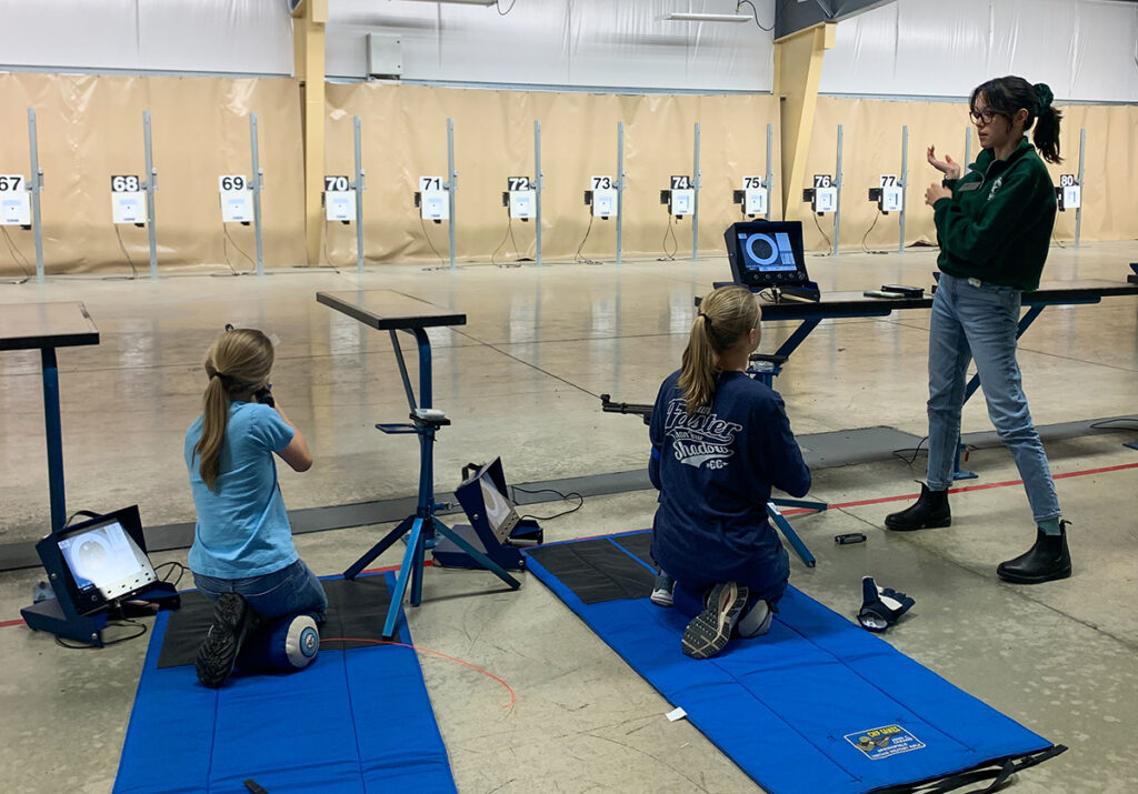CMP’s Alana Kelly (right), a former Ole Miss Rifle athlete, also assists with Junior Rifle Club training.