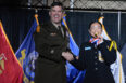 Danjela de Jesus playfully bit her precision gold medal as she received it onstage at the 2023 JROTC Nationals banquet.