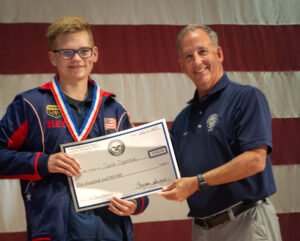 CMP Board Chairman & CEO Jerry O’Keefe presents Jack Ogoreuc with his award and check. Jack placed 1st in the Junior Olympics and 2nd overall in the CMP National Championship.