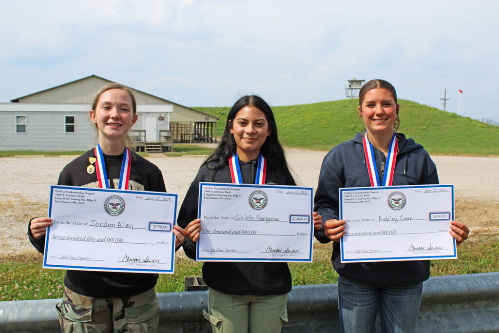 Shiloh, center, poses with her medal and award check along with the 2nd and 3rd place athletes.